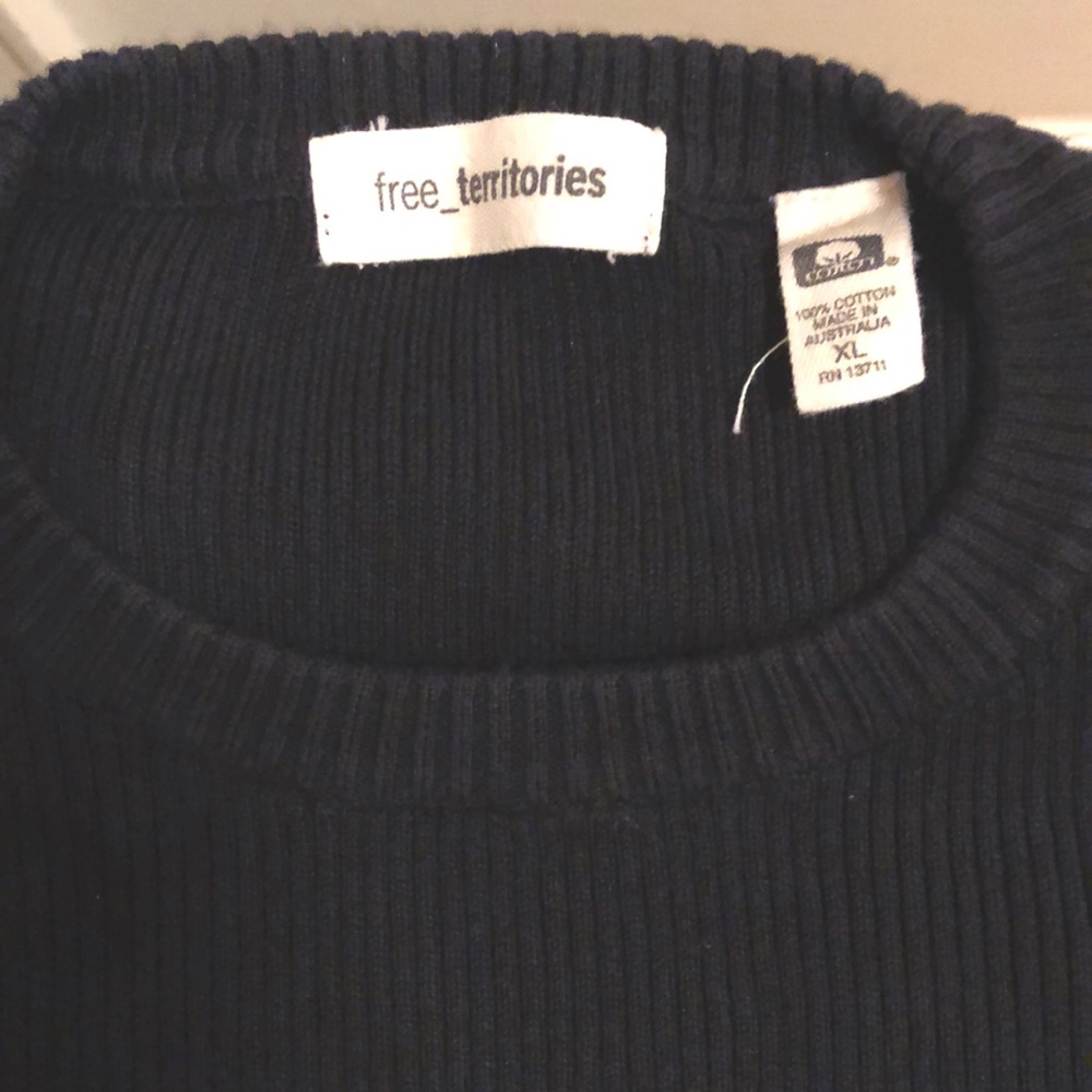Men’s long sleeve cotton sweater in black with white trim.